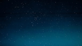 A serene night sky filled with twinkling stars over a calm landscape, evoking a sense of spiritual guidance.