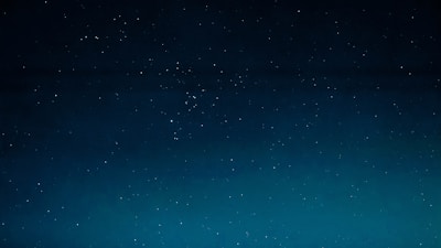 A serene night sky filled with twinkling stars forming zodiac constellations.