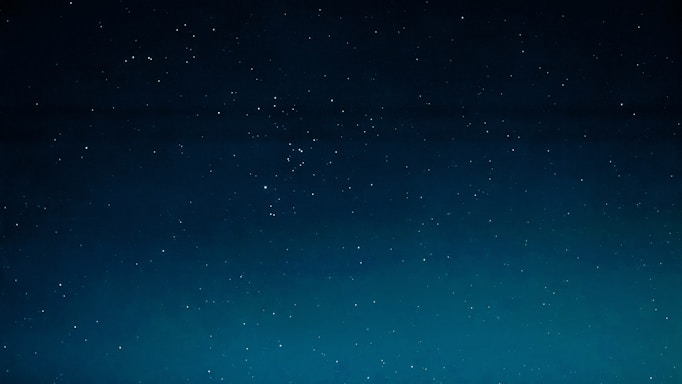 A serene night sky filled with twinkling stars over a calm landscape, reflecting the mystery of astrology.