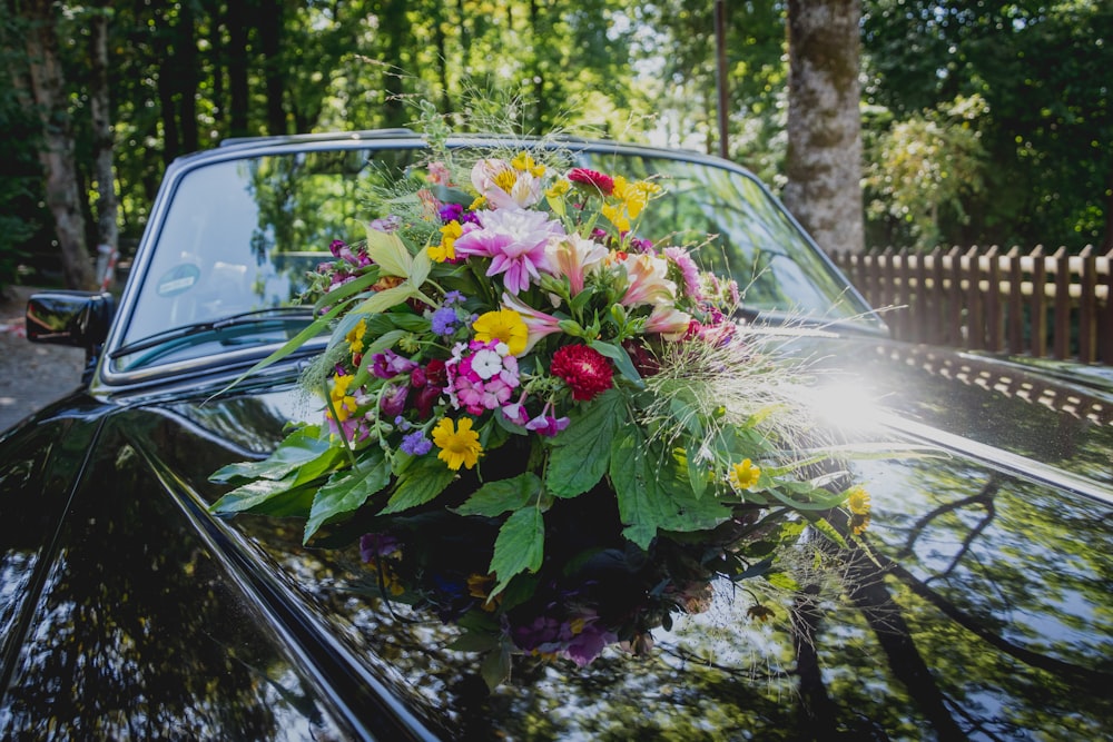 pink and white flowers on black car