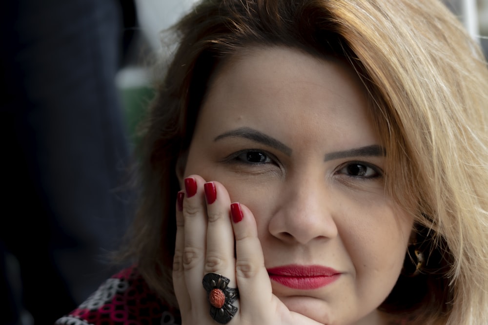 woman with red lipstick and red manicure