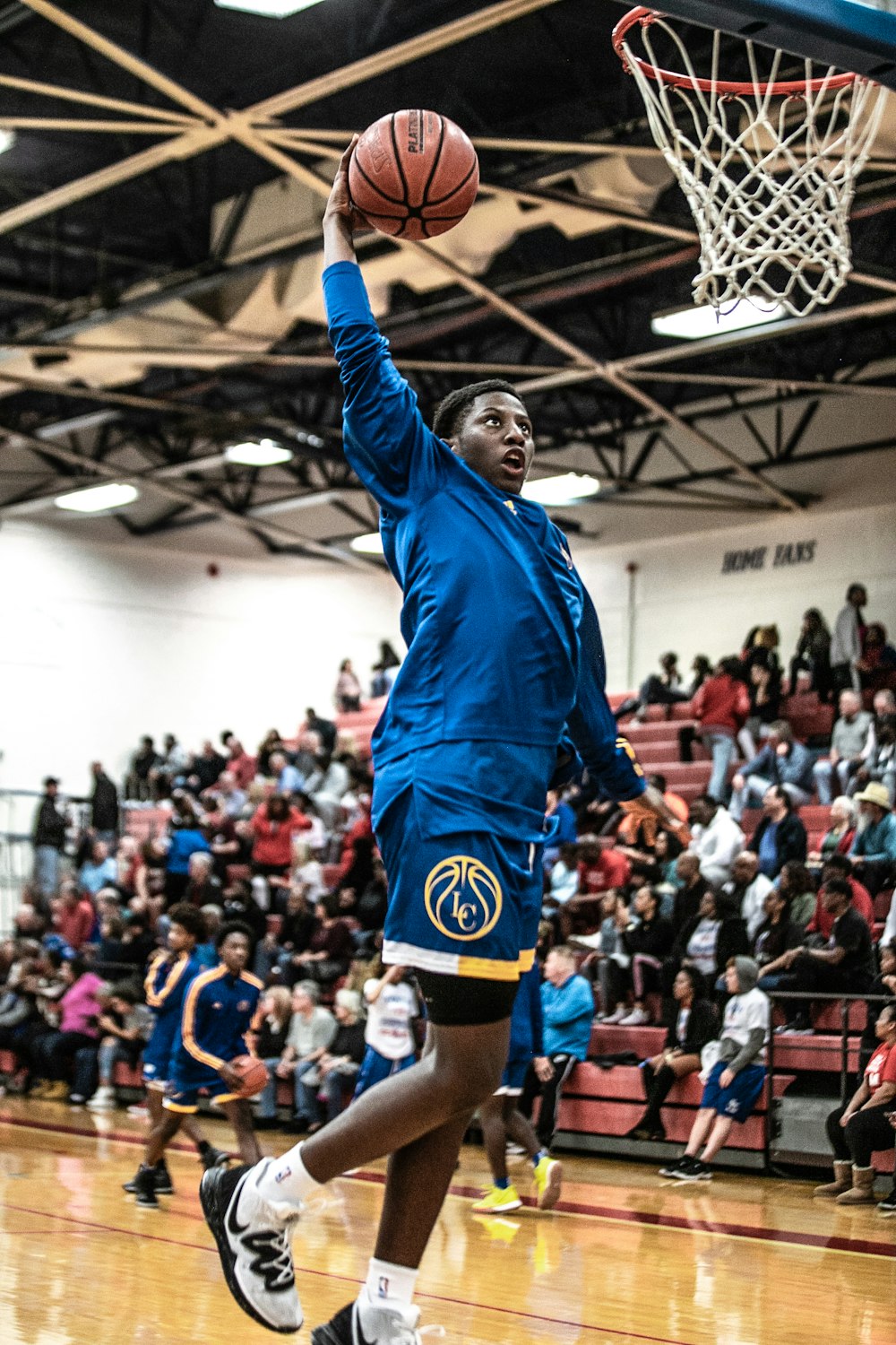 man in blue long sleeve shirt and black shorts