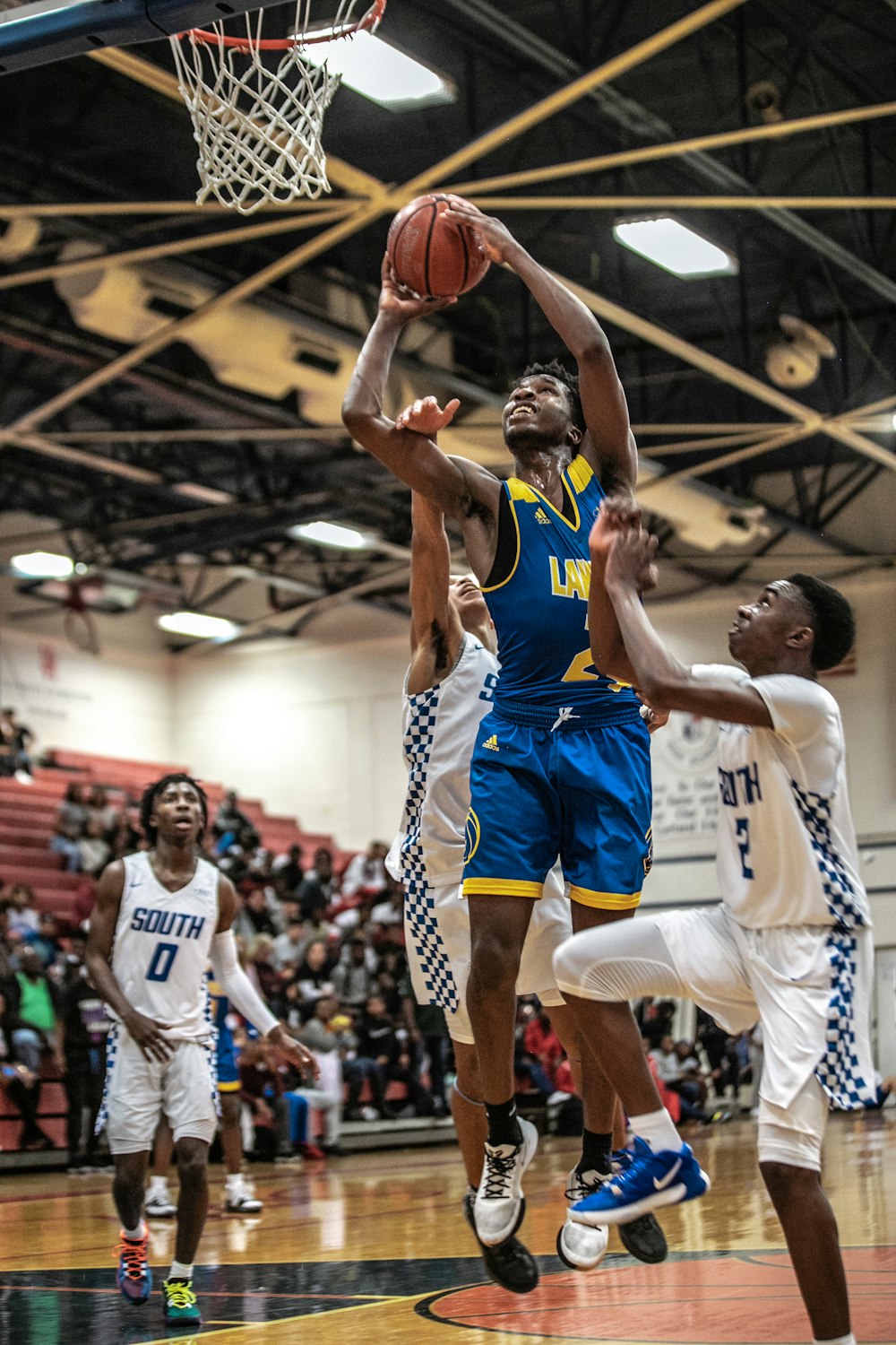 man in blue jersey shirt playing basketball