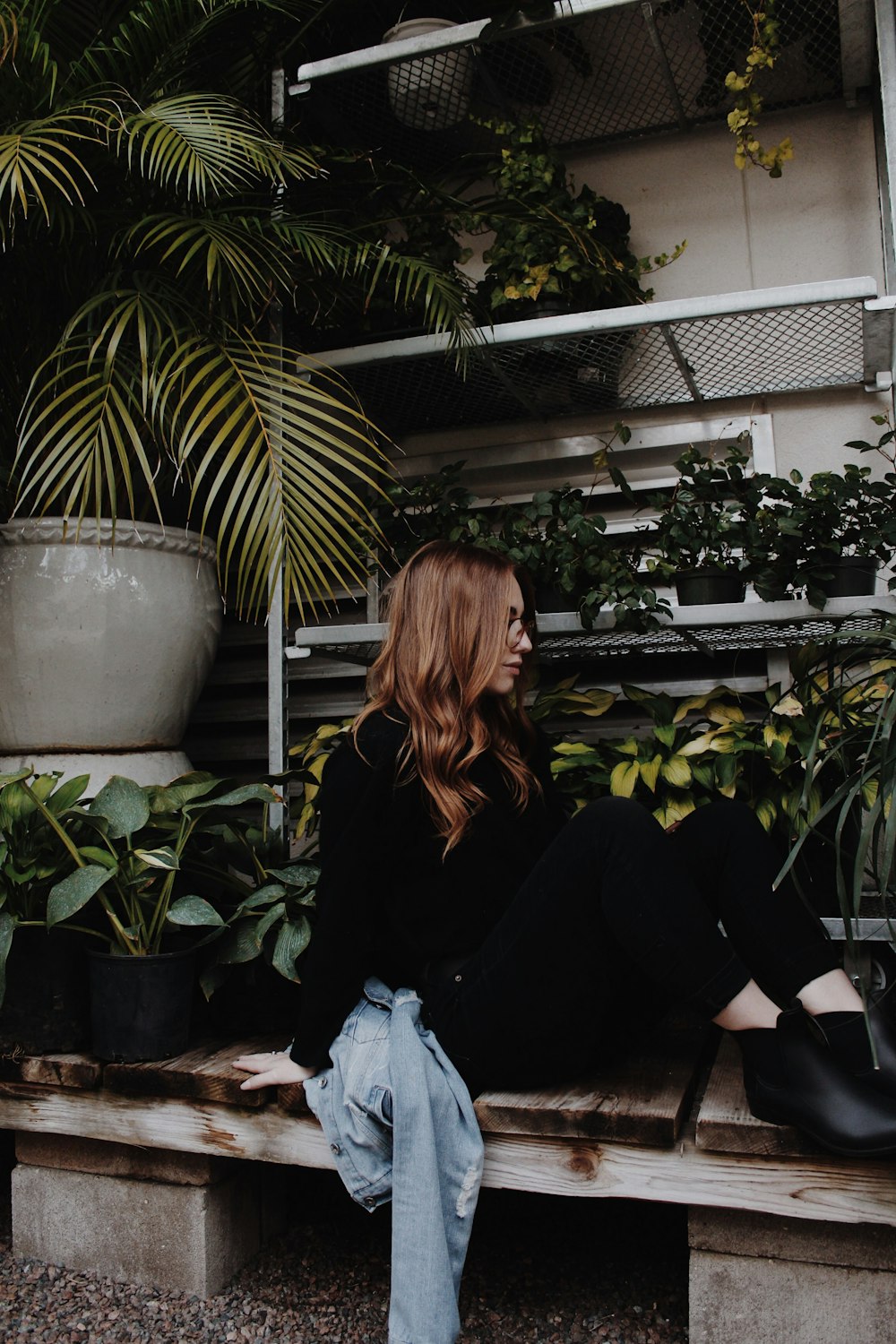 woman in black long sleeve shirt sitting on white plastic bag