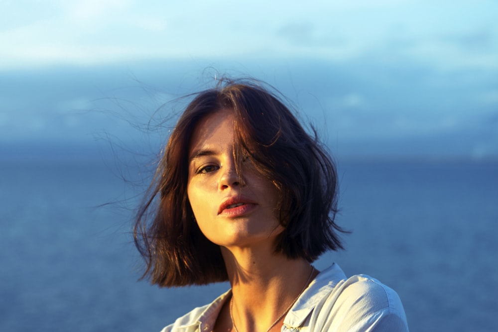 woman in white and blue stripe shirt