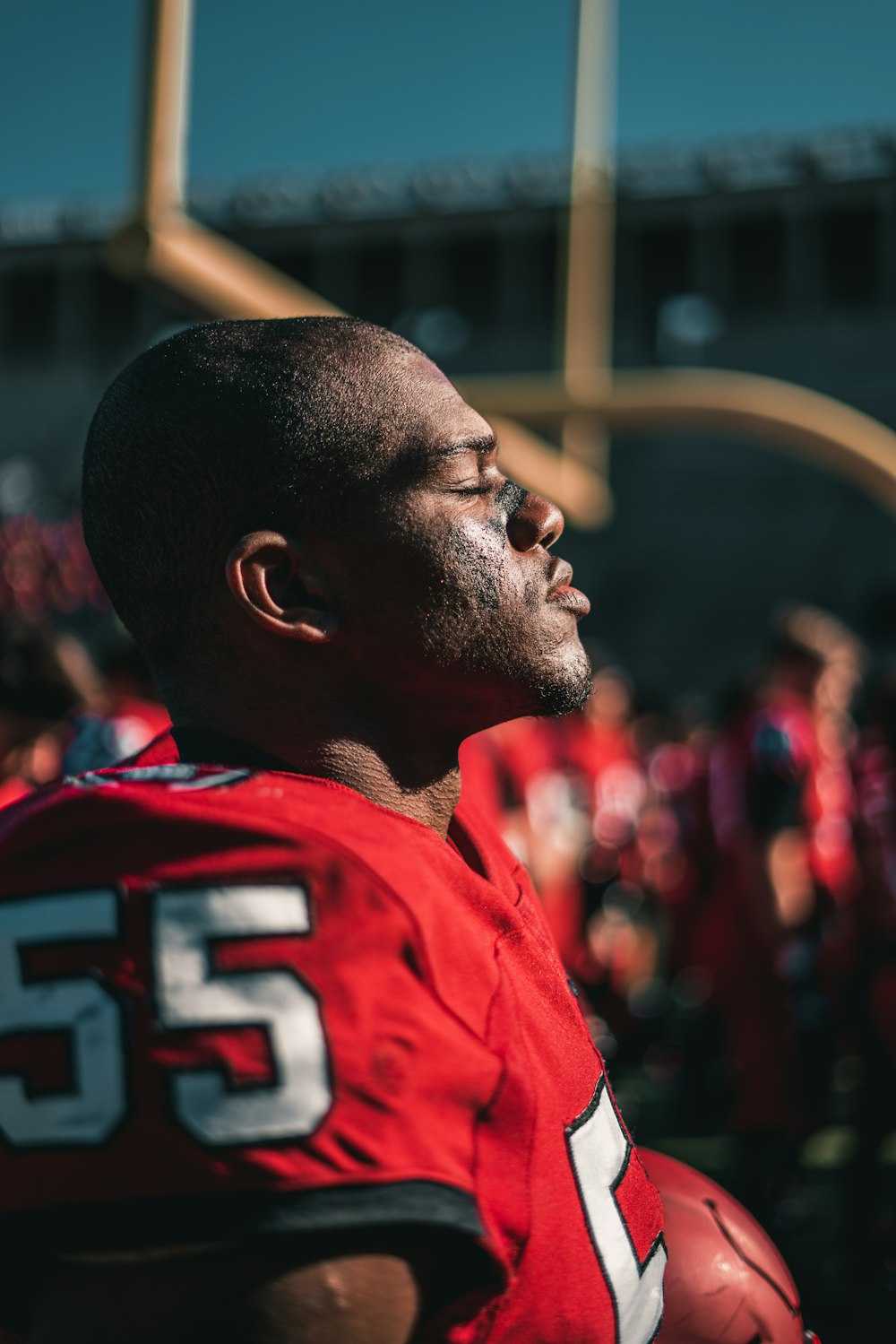 man in red and white jersey shirt