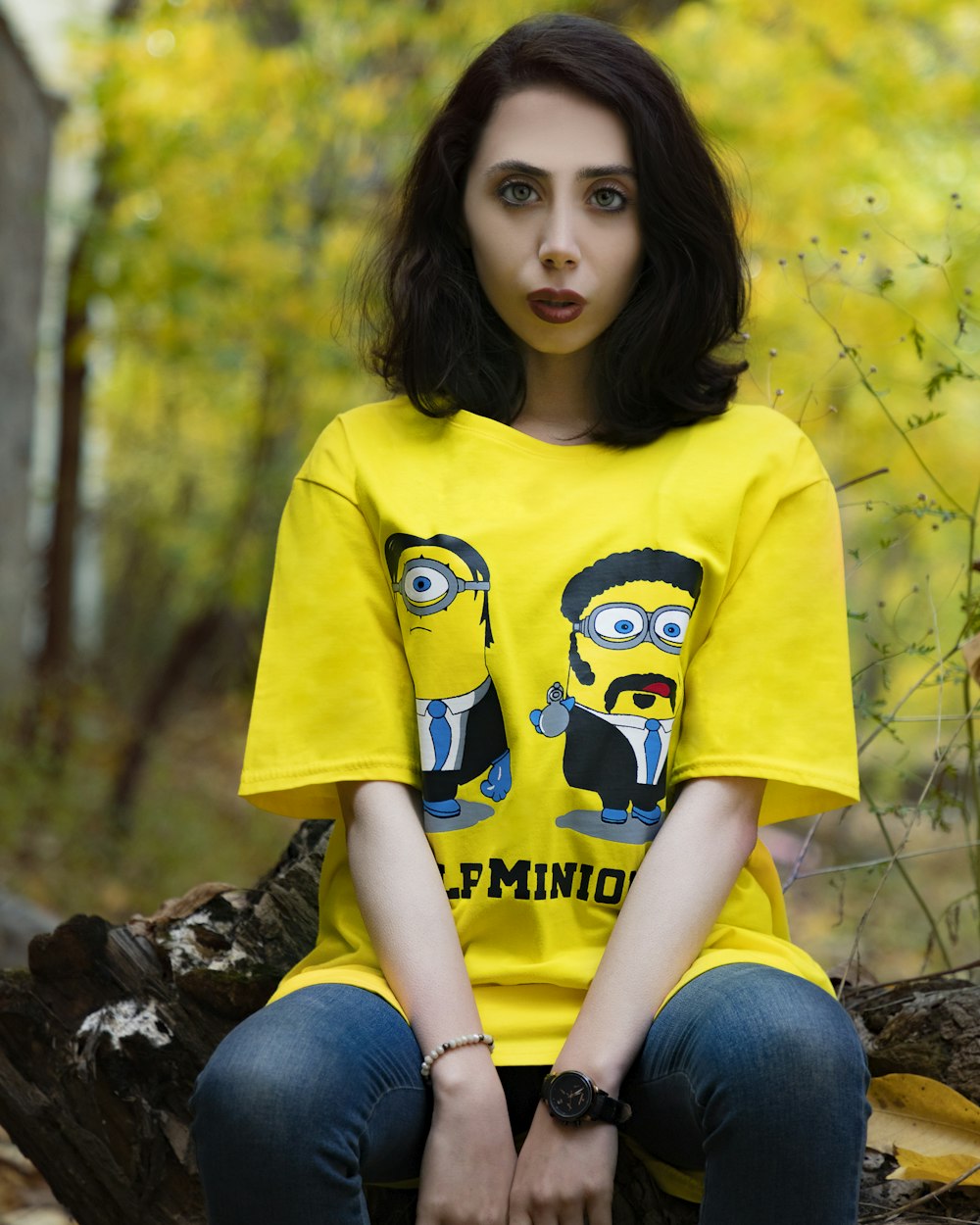 girl in yellow crew neck t-shirt and blue denim jeans sitting on brown rock during