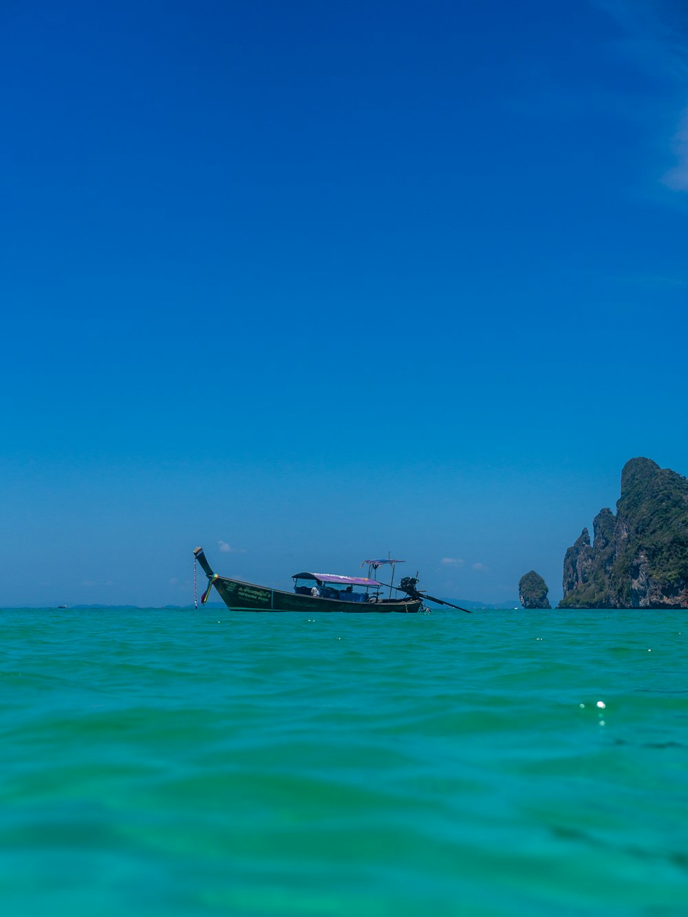 brown boat on sea during daytime