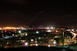 Evening scene with a luxury van illuminated under soft city lights near the airport.