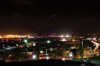 Night shot of illuminated hangars and runway at Fly Ville.