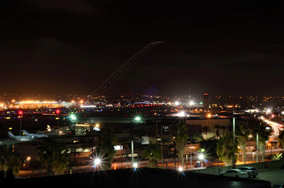 Evening scene with a luxury van illuminated under soft city lights near the airport.