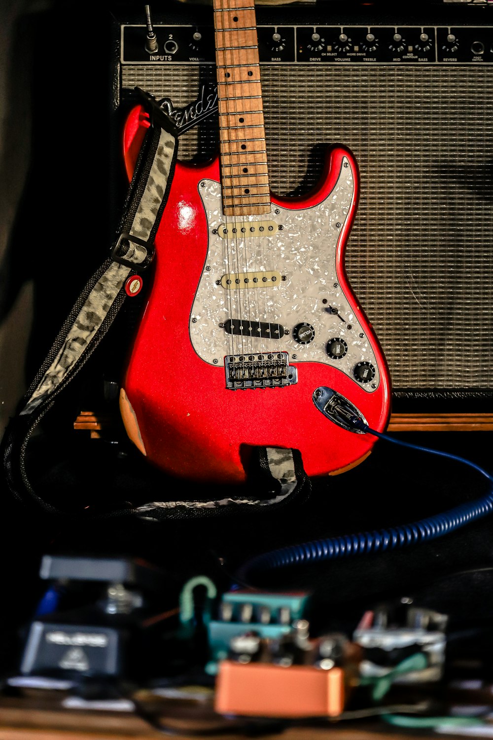 red and white stratocaster electric guitar