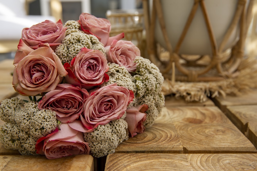 pink roses bouquet on brown wooden table