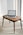 A laptop is placed on a small wooden table in a room with light-colored carpet and vertical blinds. The laptop screen displays a webpage titled 'Interactive RFID', indicating a focus on technology.