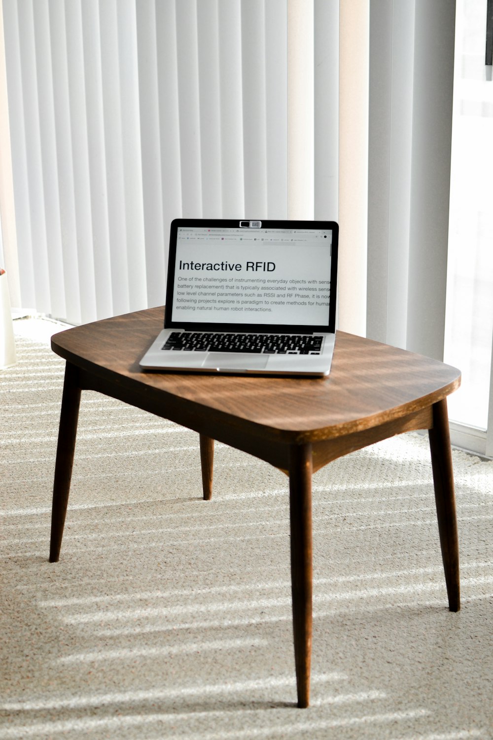 black laptop computer on brown wooden table