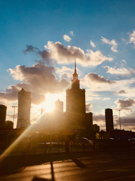 A behind-the-scenes shot of a film crew capturing a dramatic cityscape at sunset.
