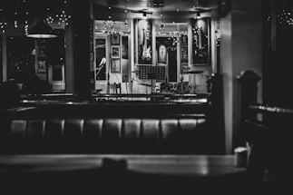 A cozy, dimly lit jazz club interior with a small stage and vintage instruments ready for a live blues performance.