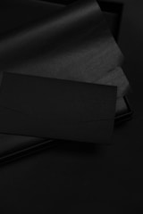 Corporate identity materials including letterheads and envelopes with sleek design on dark backgrounds.
