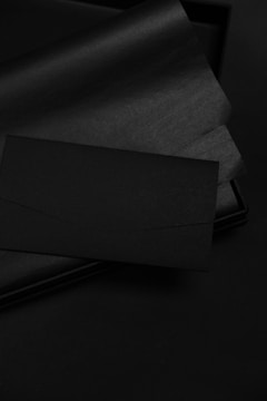 Corporate identity materials including letterheads and envelopes with sleek design on dark backgrounds.