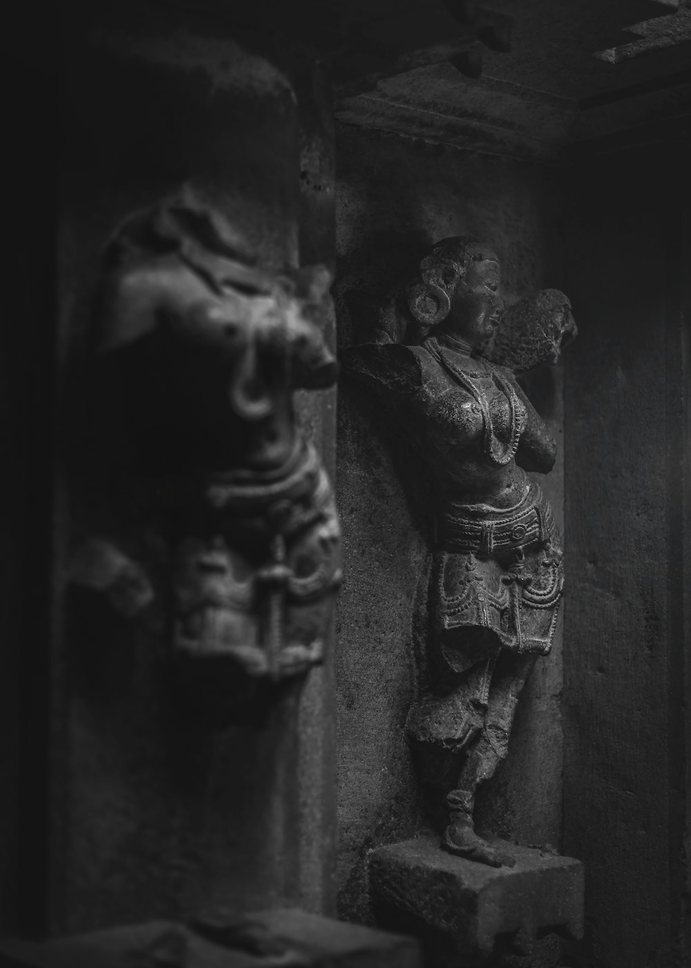 gray scale photo of man and woman statue