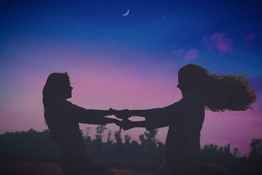 Two silhouetted figures reaching out under a starlit sky, tangled in glowing threads of fate.