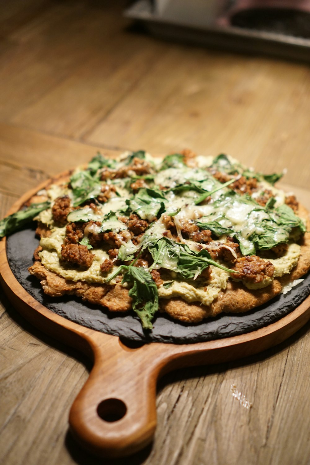 brown and green dish on brown wooden round plate