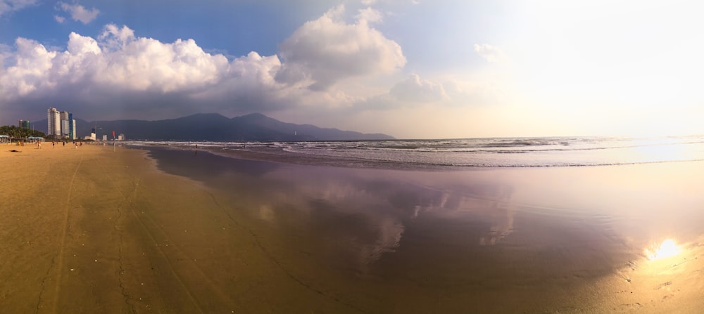 body of water under white clouds and blue sky during daytime