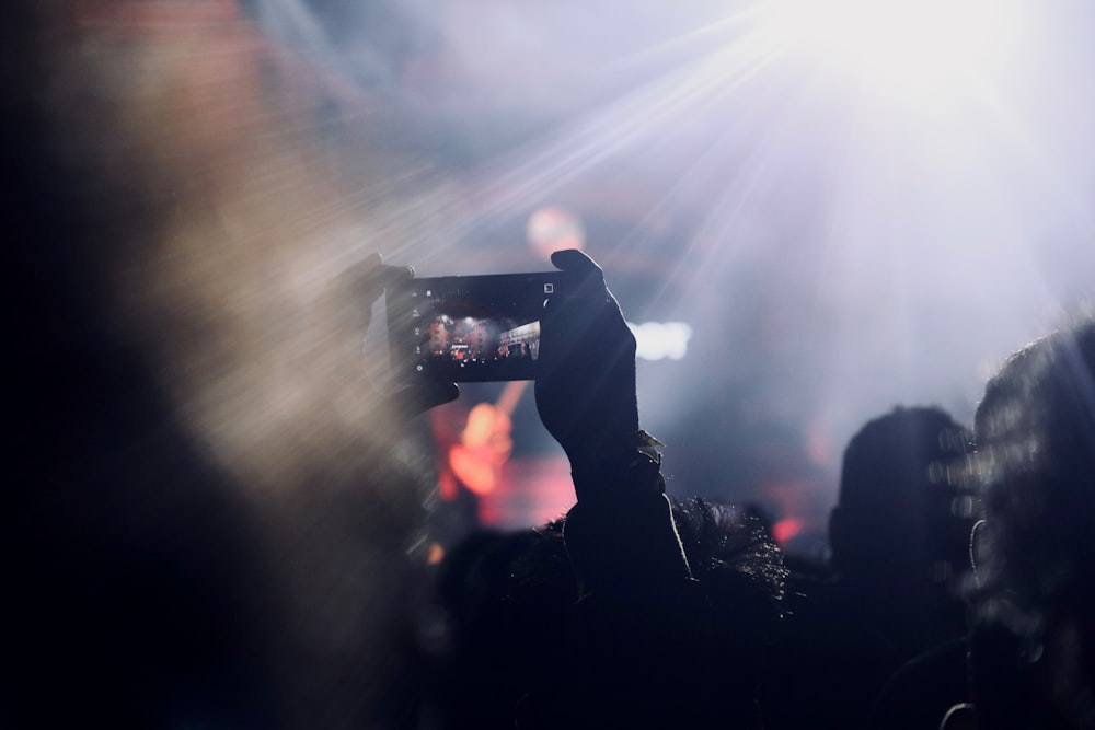 silhouette of people standing on stage