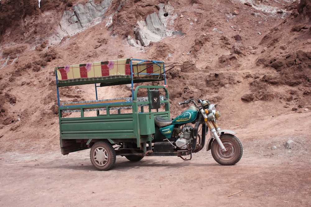 green and brown vintage car on brown dirt road during daytime