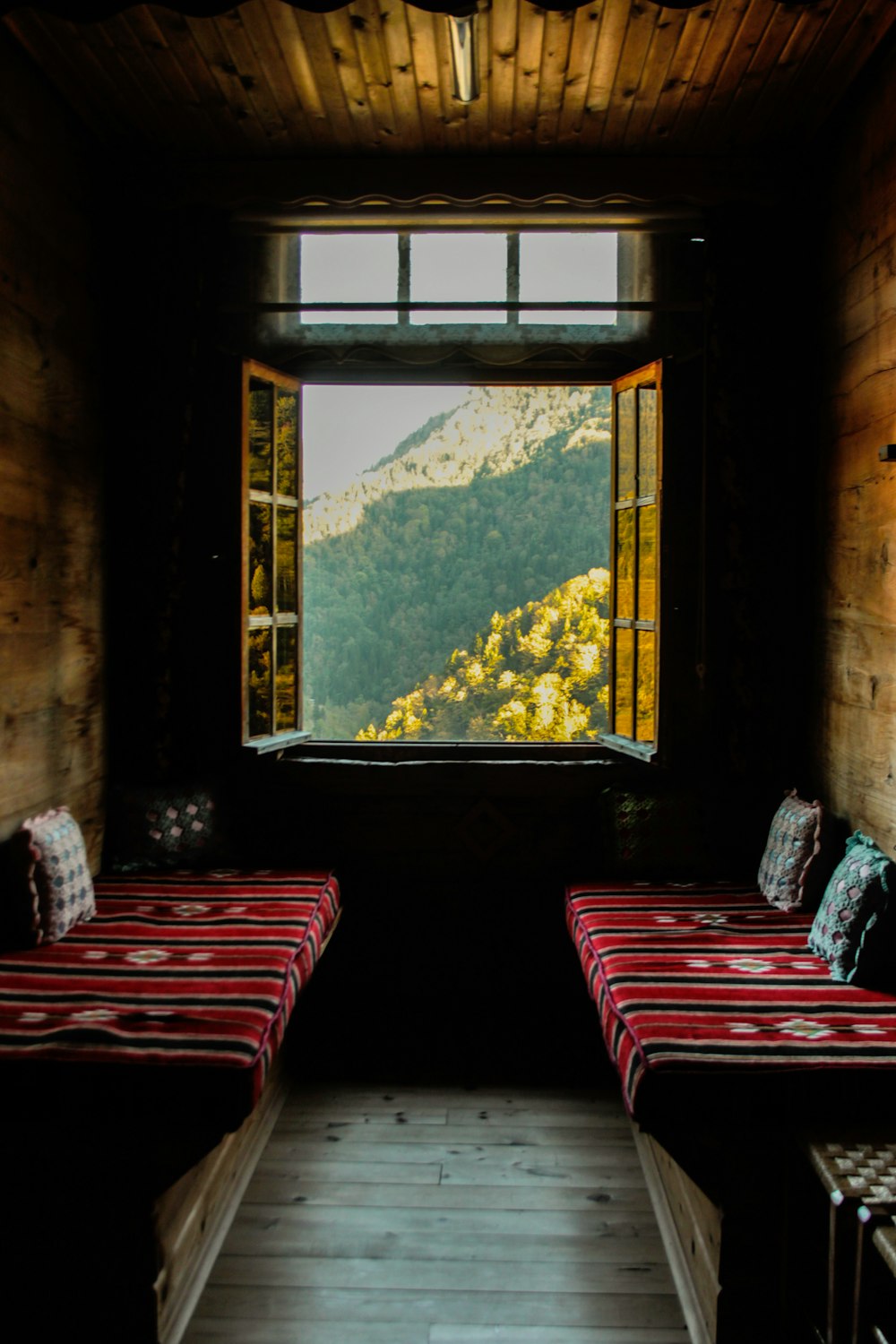 red and white striped sofa chairs near window