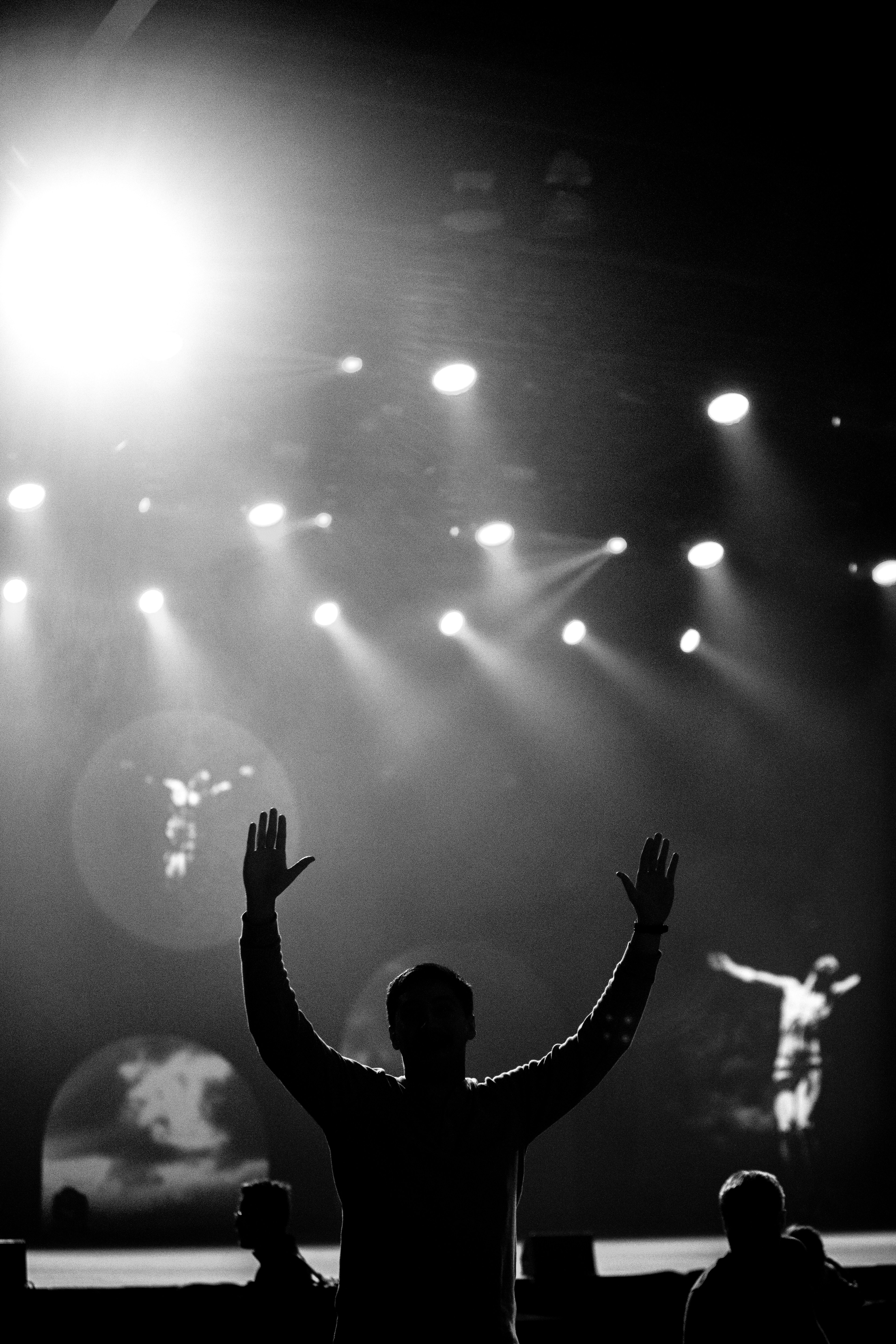 a man standing in front of a crowd at a concert