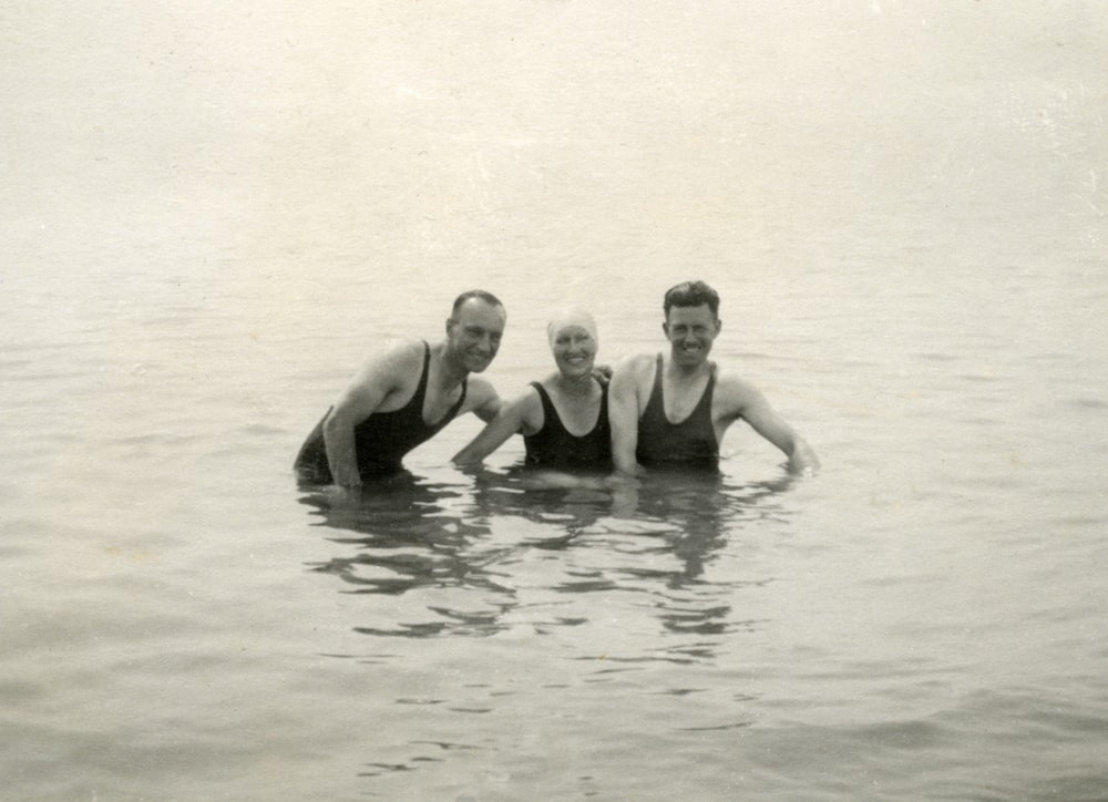 2 men in swimming trunks in water