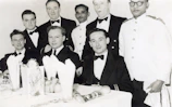 Fraternity members dressed in formal attire at a gala event.