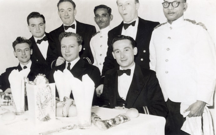 A group of men dressed in coordinated formal attire.