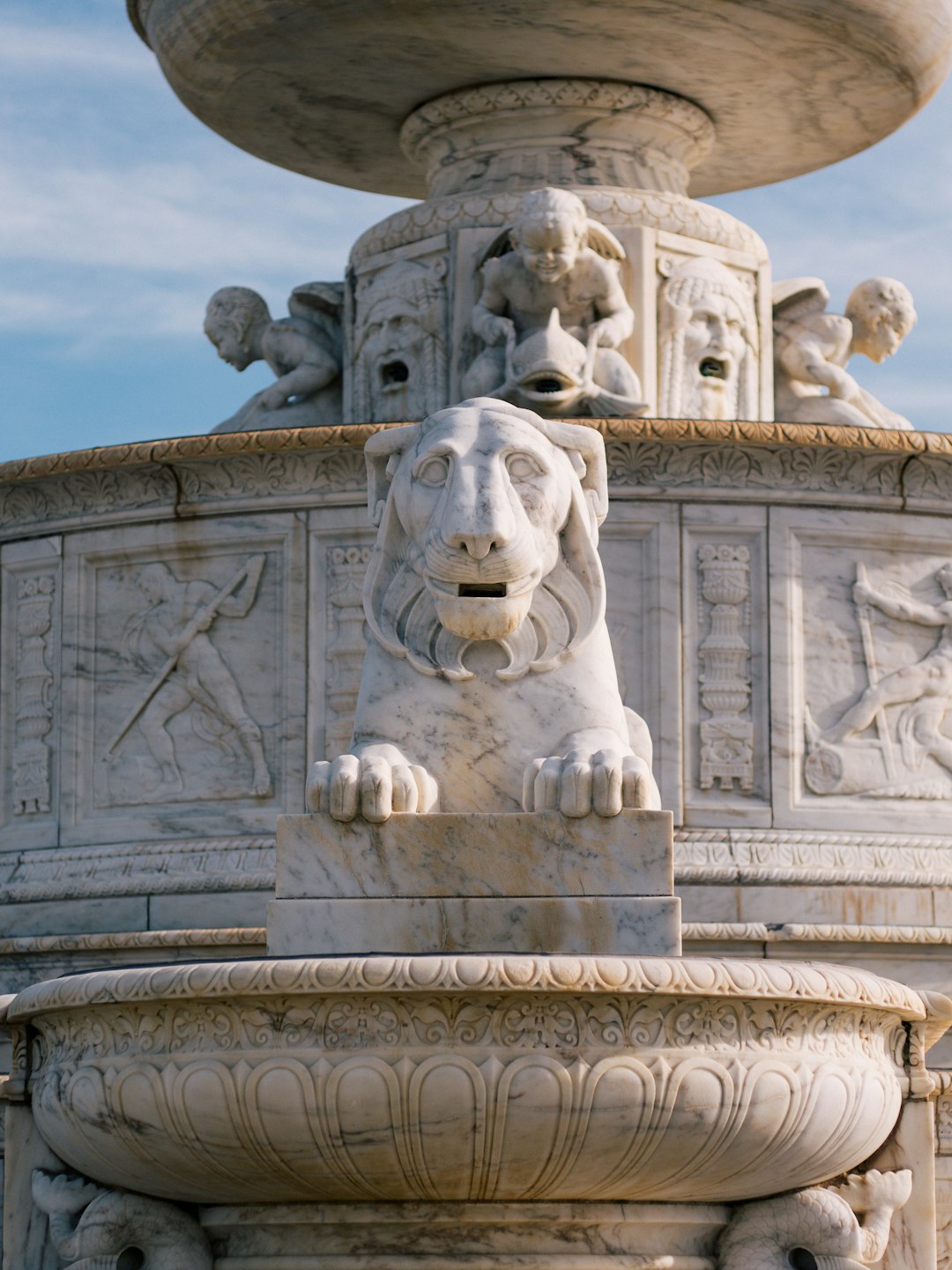 white concrete lion statue under blue sky during daytime