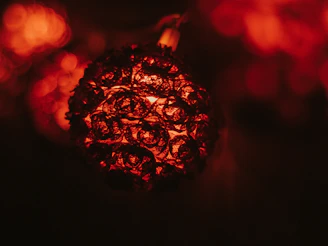 A close-up of a handcrafted copper art piece glowing warmly under soft light.