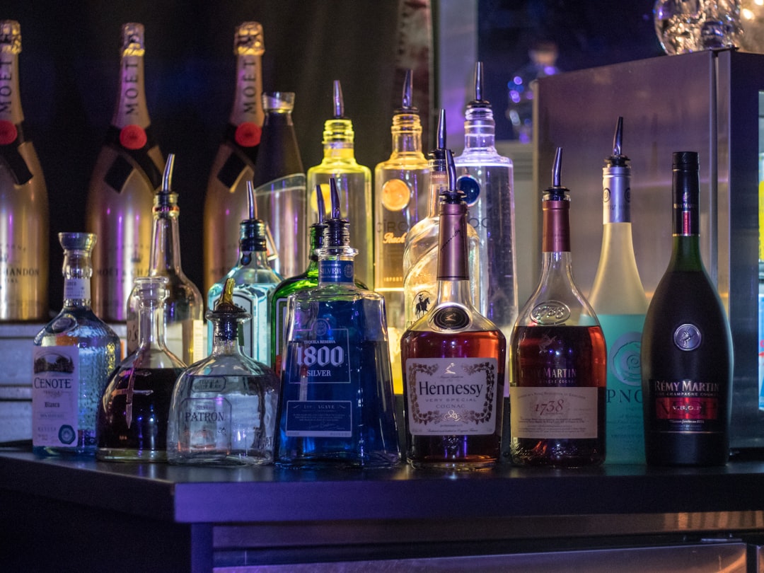 assorted glass bottles on brown wooden table