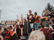 A cheerful group of students wearing spiritique apparel at a varsity game.