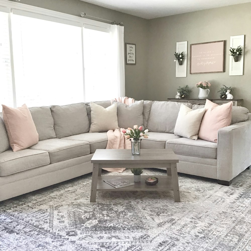 brown wooden coffee table near white couch