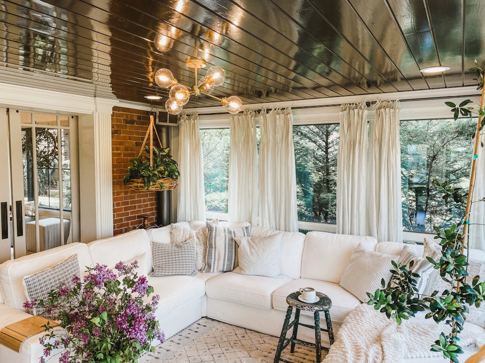 white and pink floral sofa near window