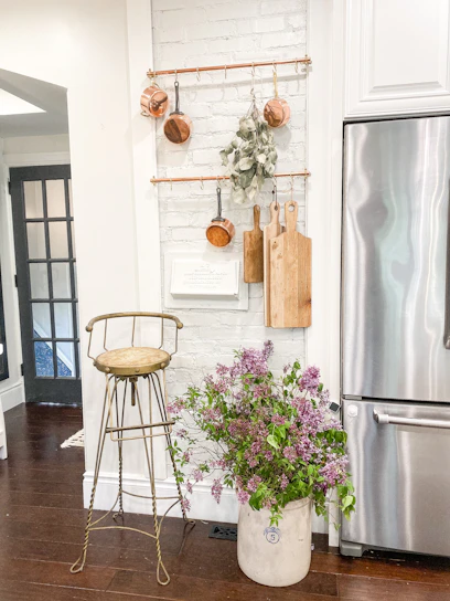 A cozy, stylish kitchen corner featuring sleek utensils and vibrant purple accents.