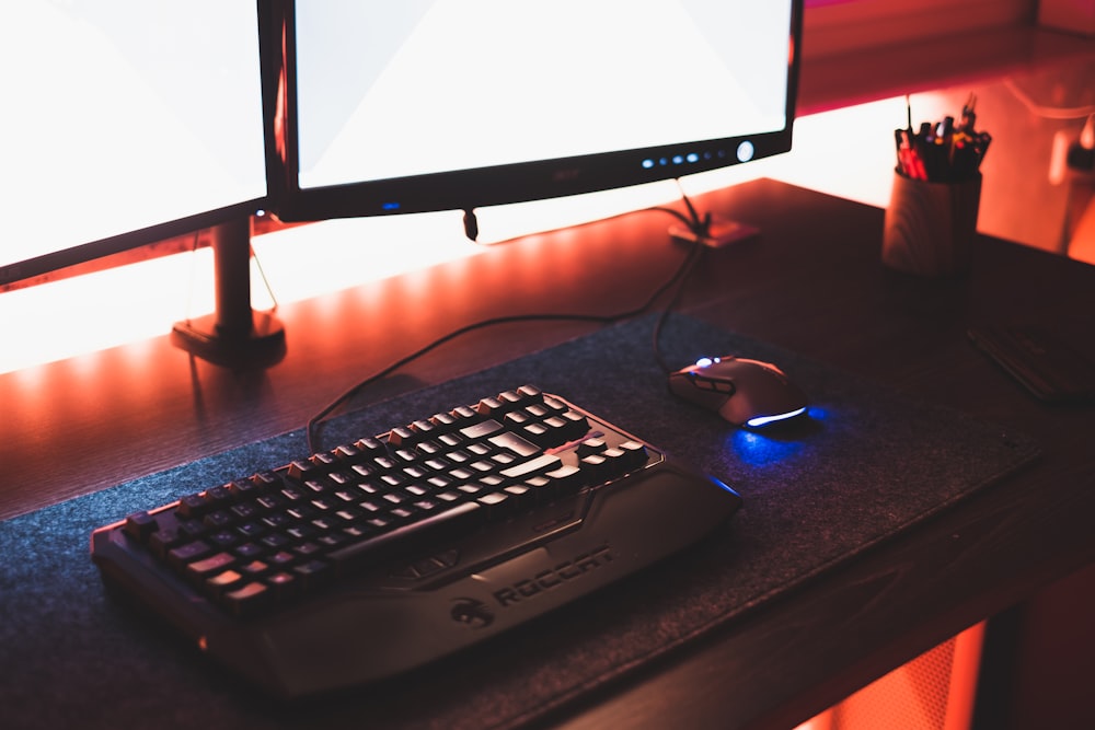 black flat screen computer monitor on brown wooden desk