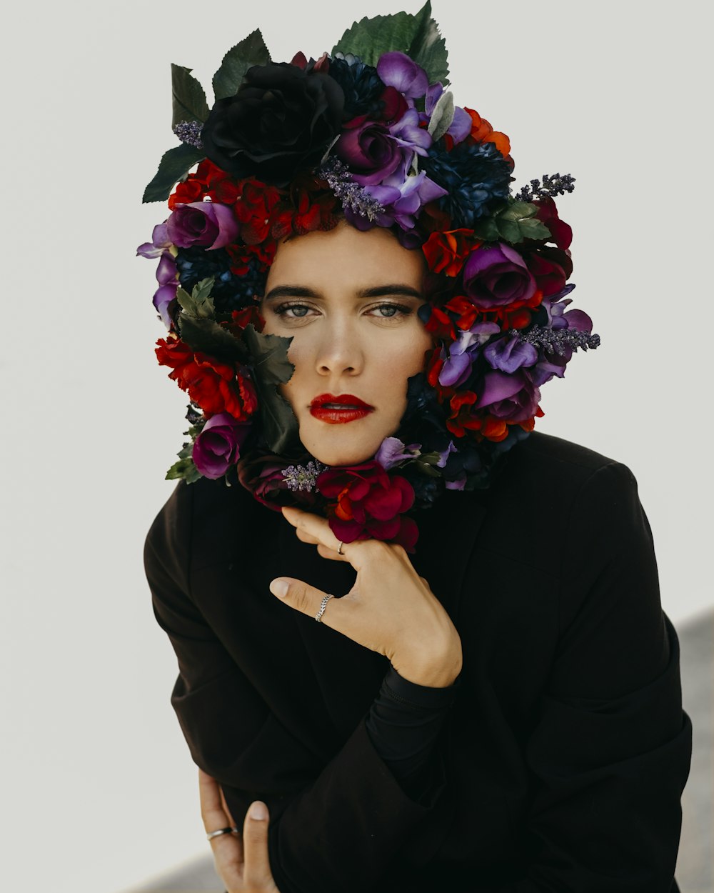 woman in black long sleeve shirt with red rose on her face