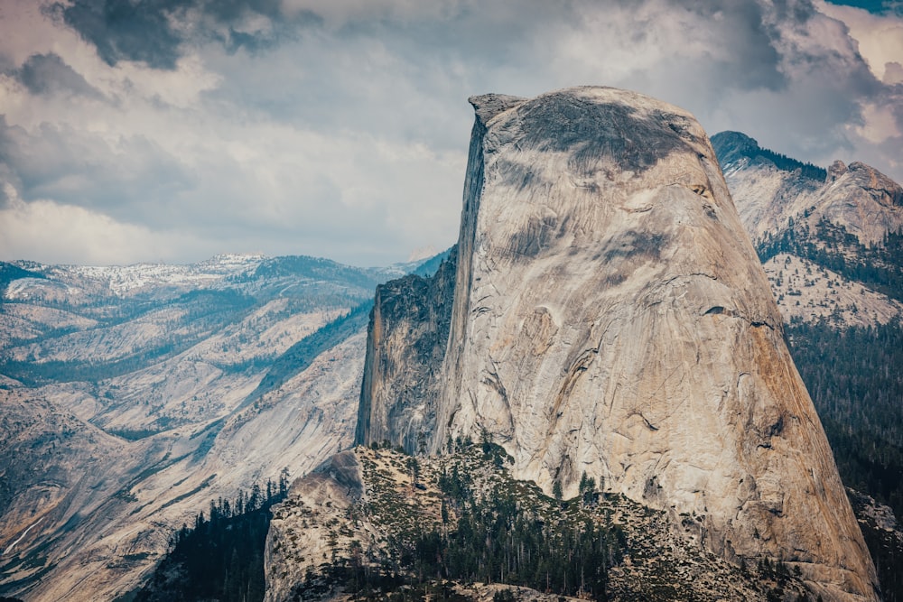 a view of the top of a mountain with a cloudy sky