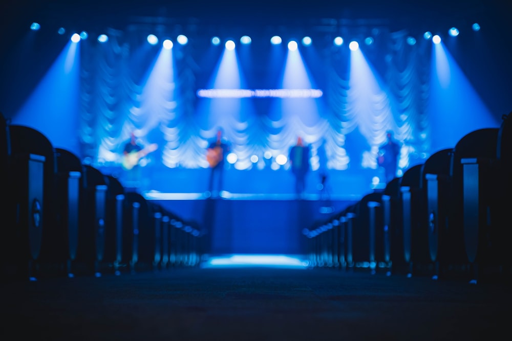 people standing on stage with blue lights