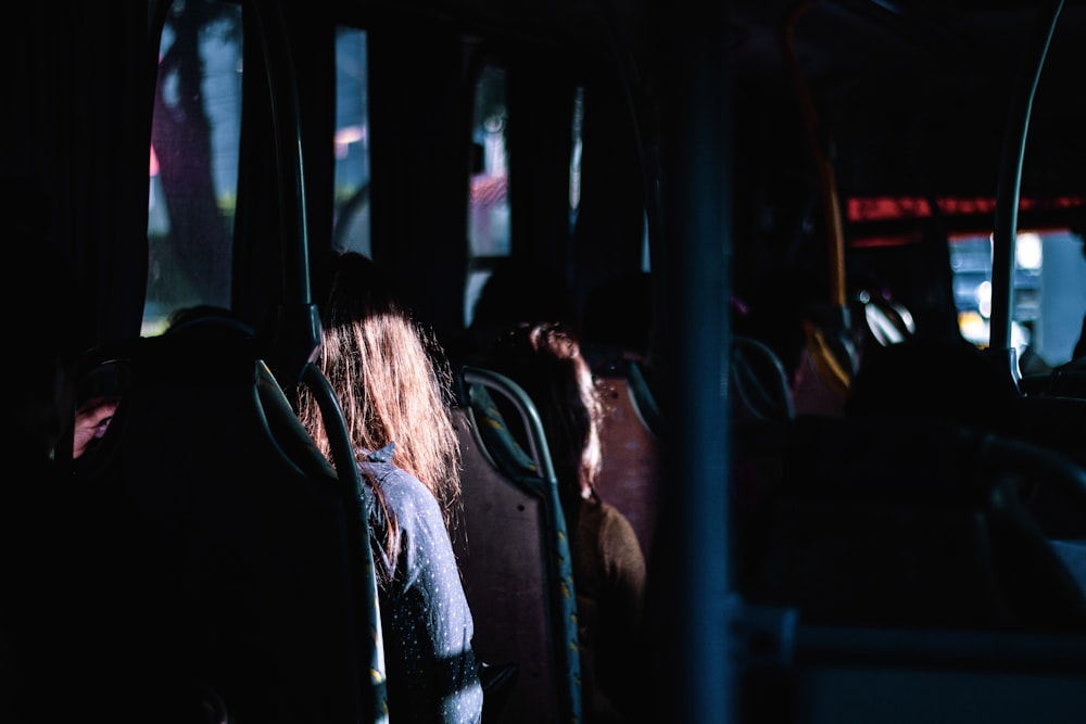 woman in blue denim jacket sitting inside car