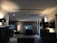 Photo of a modern living room softly illuminated by smart lighting installed by Dim Electrical.