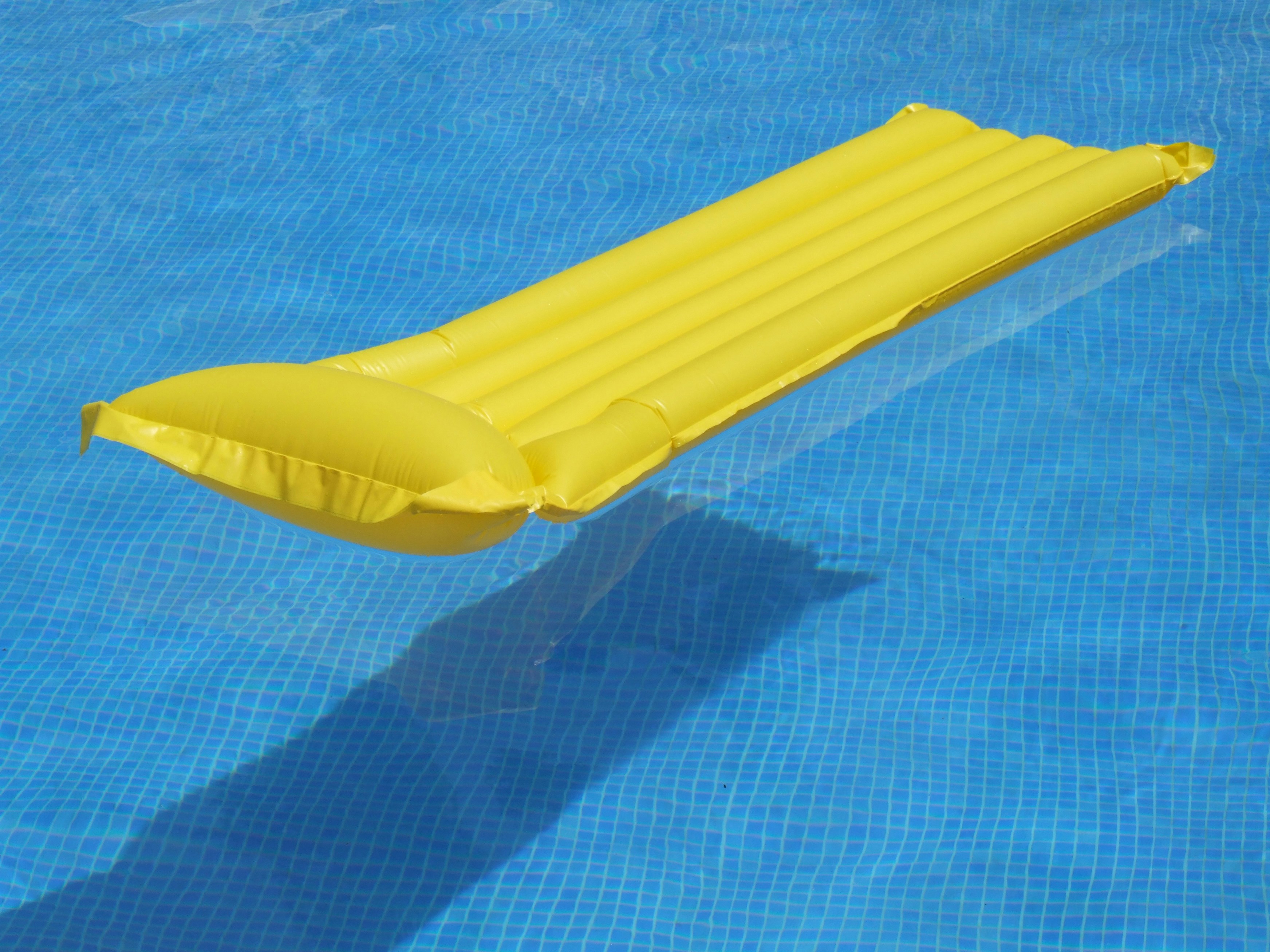yellow inflatable ring on blue textile