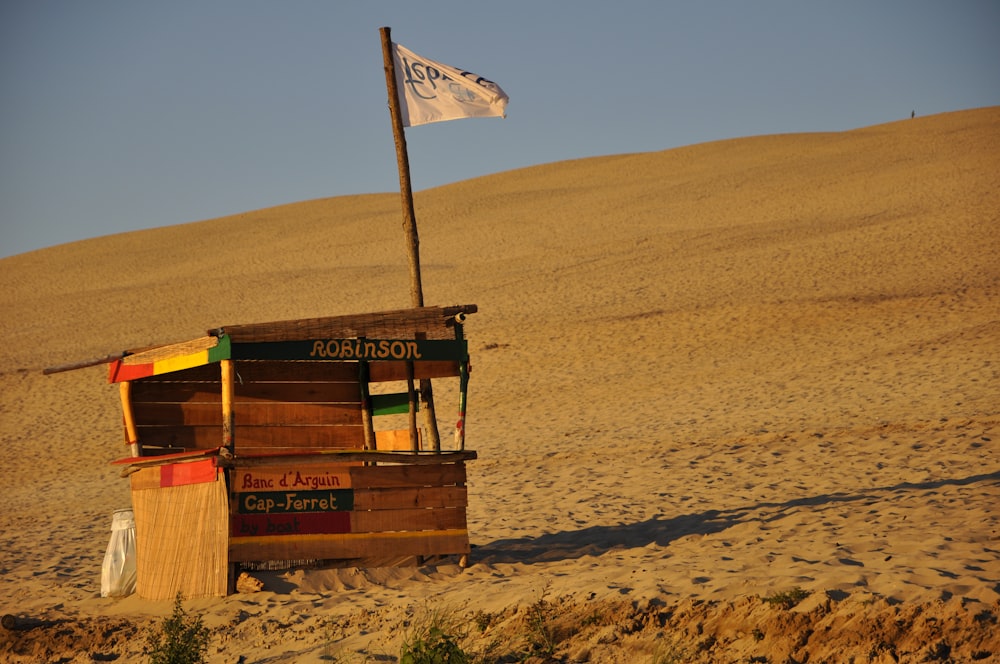 brown wooden utility trailer on brown sand during daytime