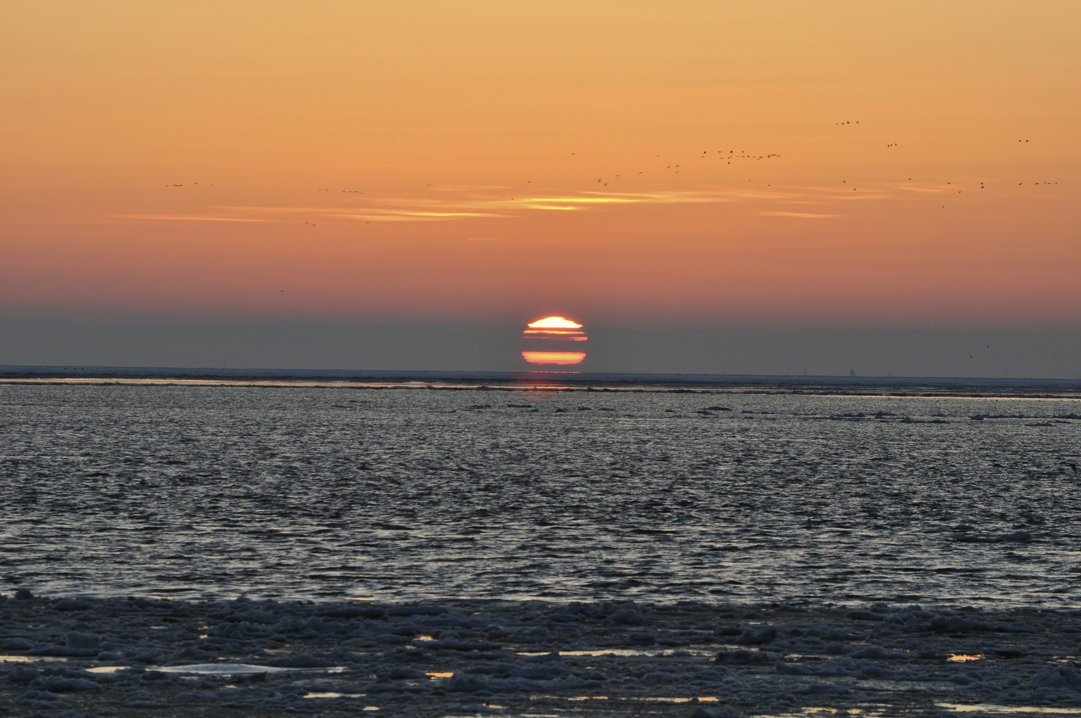 body of water during sunset